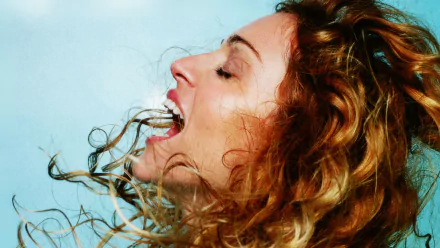 HD desktop wallpaper featuring a close-up of Madonna with flowing hair, captured in a dynamic moment expressing passion for music.