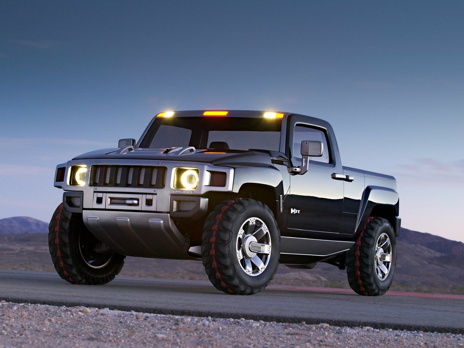 HD PC desktop wallpaper: Hummer H3T Concept vehicle — silver Hummer pickup on a desert plain at dusk with headlights and amber roof lights glowing.