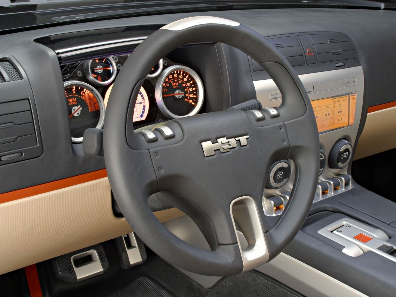 Close-up interior of a Hummer H3T Concept vehicle showing steering wheel, illuminated gauges and center console — HD PC desktop wallpaper/background.