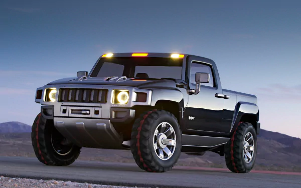 HD PC desktop wallpaper: Hummer H3T Concept vehicle — silver Hummer pickup on a desert plain at dusk with headlights and amber roof lights glowing.