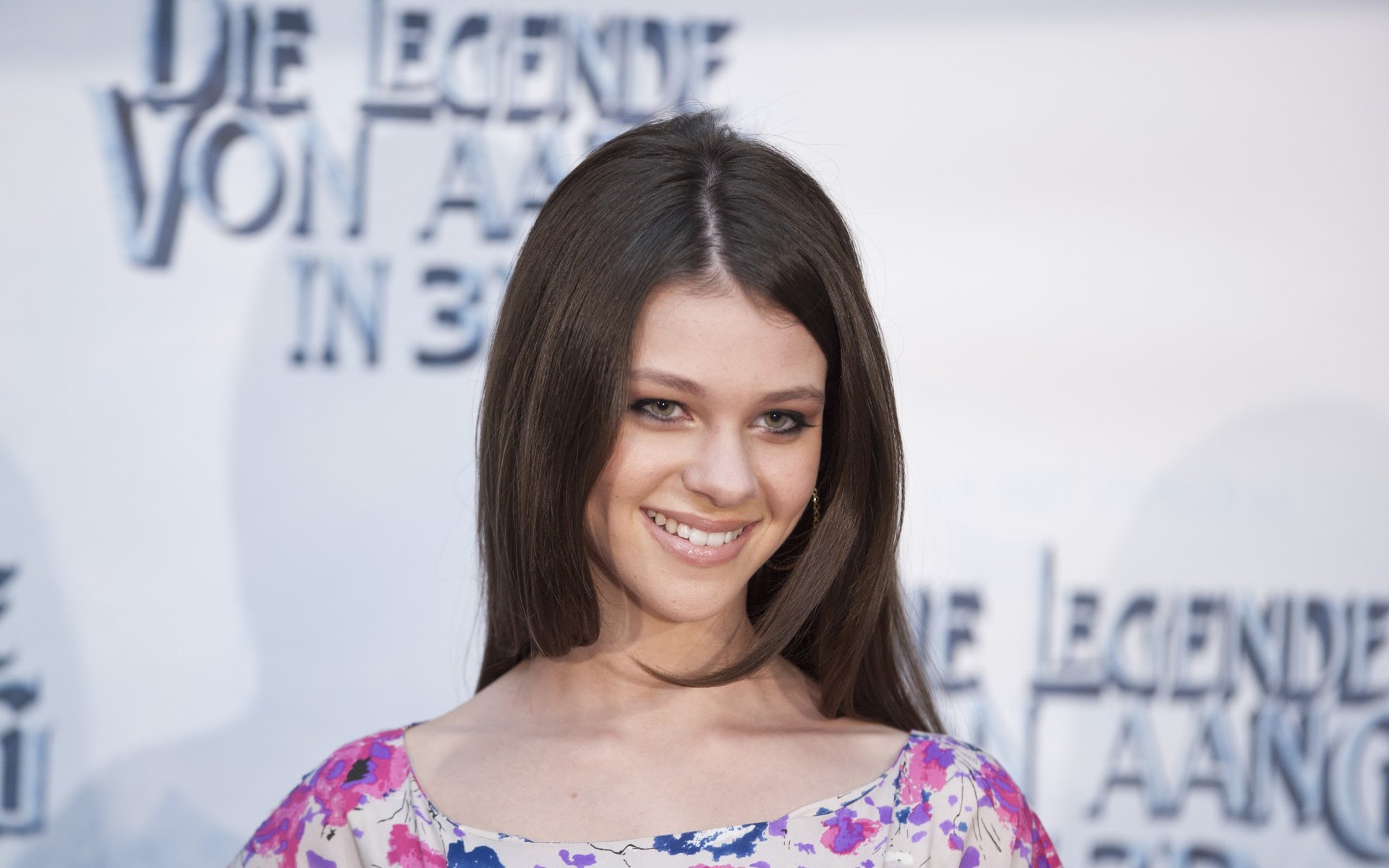 HD desktop wallpaper featuring American actress and celebrity Nicola Peltz smiling at a red carpet event.