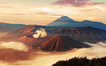 A stunning view of Mount Bromo at sunrise, showcasing its majestic volcanic landscape surrounded by mist and vibrant colors. An inspiring nature backdrop for any desktop wallpaper.