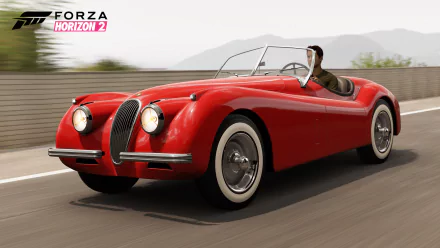 HD PC desktop wallpaper featuring a classic red convertible car from the video game Forza Horizon 2, captured in dynamic motion on a scenic road.