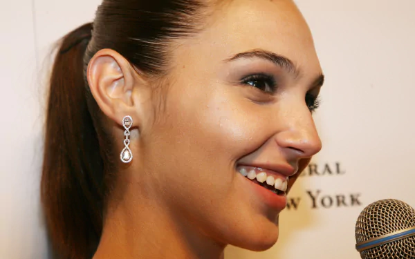 Close-up of Israeli actress and celebrity Gal Gadot smiling, featured in a high-definition PC desktop wallpaper background.