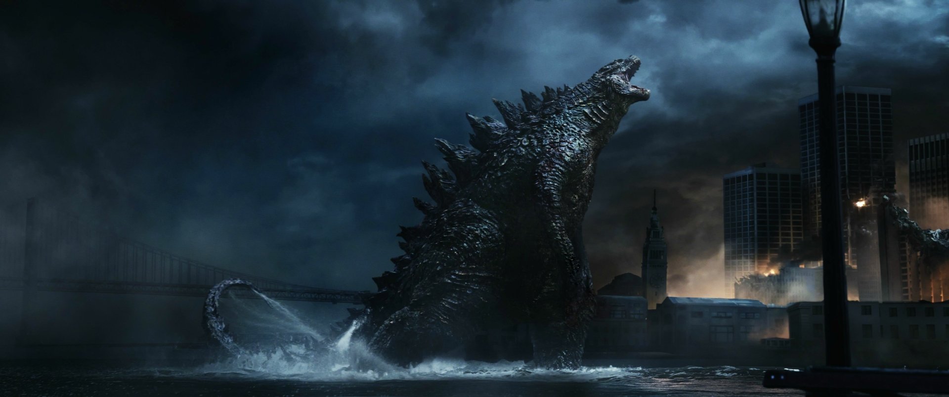 A dramatic HD wallpaper featuring Godzilla from the 2014 movie, showcasing the iconic monster emerging from the water against a backdrop of dark, stormy skies and city ruins.