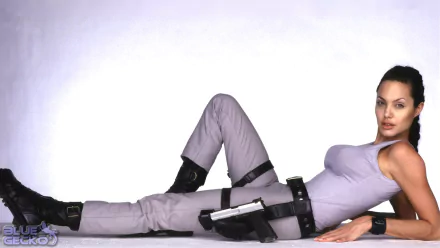 HD PC desktop wallpaper featuring Lara Croft from the movie Lara Croft: Tomb Raider in a relaxed, reclining pose with her signature outfit and weapons.