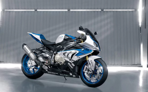 HD PC desktop wallpaper and background showing a blue-and-white BMW HP4 sport motorcycle in side profile on a reflective garage floor with racing livery.