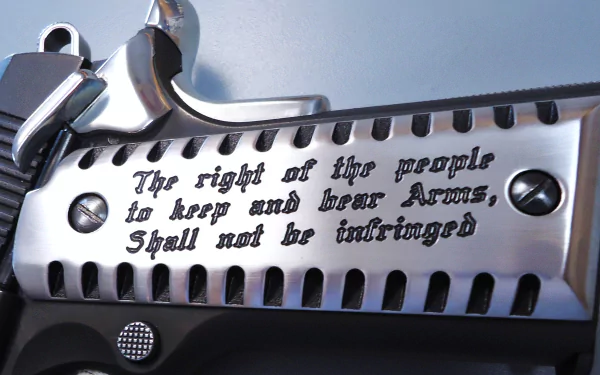 HD PC desktop wallpaper featuring a close-up of a firearm engraved with the text of the 2nd Amendment: The right of the people to keep and bear Arms, Shall not be infringed.