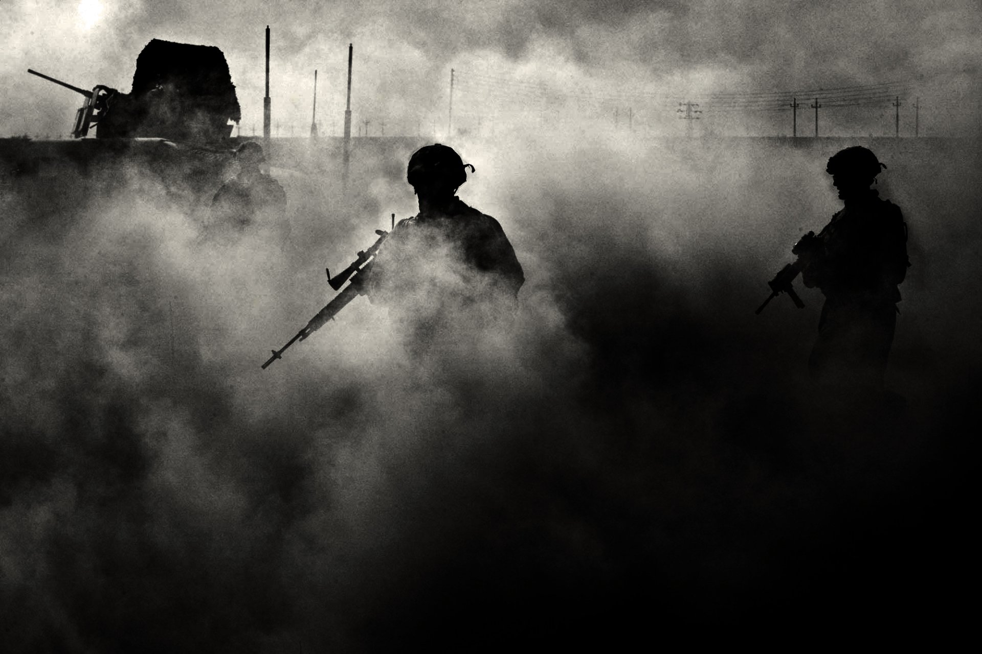 Artistic HD desktop wallpaper featuring the silhouettes of military soldiers moving through dense smoke.