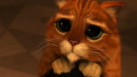 Close-up HD image of Puss in Boots from the movie, showing the cat with large, pleading eyes. This character is set against a simple, blurred background, making it a striking desktop wallpaper.