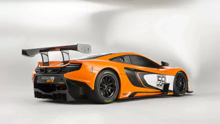 Orange McLaren 650S GT3 supercar in orange race livery with large rear wing, rear three-quarter view — 2K Quad HD PC desktop wallpaper.