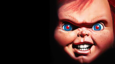 HD PC desktop wallpaper featuring a close-up of the menacing doll from the movie Child's Play 3 with glowing blue eyes and a sinister grin against a black background.