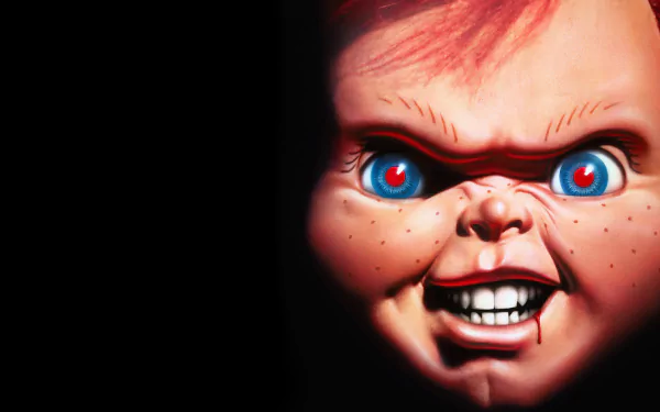 HD PC desktop wallpaper featuring a close-up of the menacing doll from the movie Child's Play 3 with glowing blue eyes and a sinister grin against a black background.