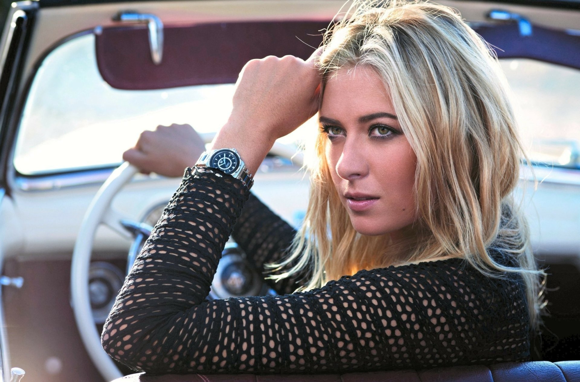 HD desktop wallpaper featuring Maria Sharapova in a sports-themed image, seated confidently in a car with a focused expression.