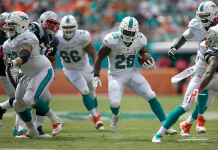 HD PC desktop wallpaper featuring Miami Dolphins players in action during a football game, showcasing dynamic sports moments on the field.
