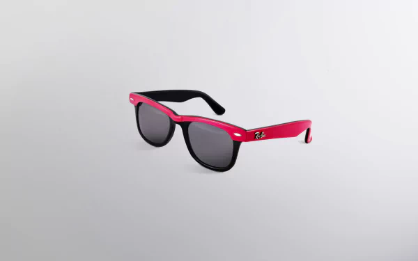 Man-made pink Ray-Ban sunglasses with black lenses on a minimalist gray backdrop — HD PC desktop wallpaper and background.