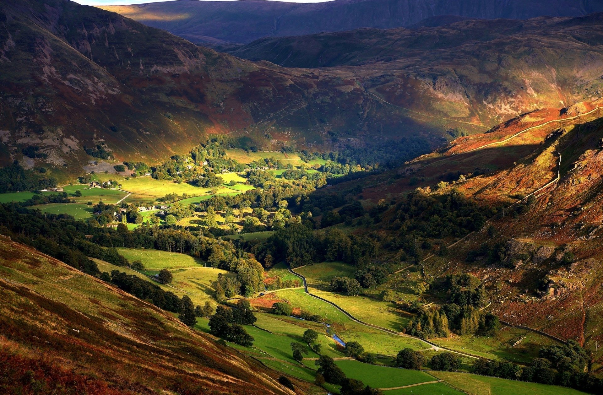 Sunlit valley and shadowed mountains in England, showcasing vibrant nature in this HD desktop wallpaper and background.