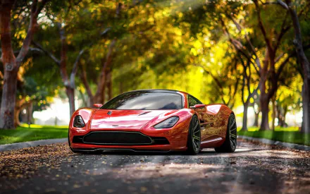 A sleek Aston Martin DBC concept car showcased on a picturesque tree-lined road, capturing the elegance of the Aston Martin DBS in a vibrant autumn setting.