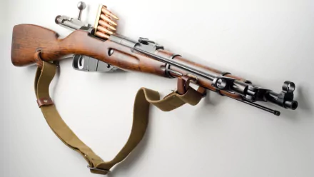 HD desktop wallpaper featuring a detailed image of a man-made Mosin Nagant rifle with wooden stock and attached ammunition clips.