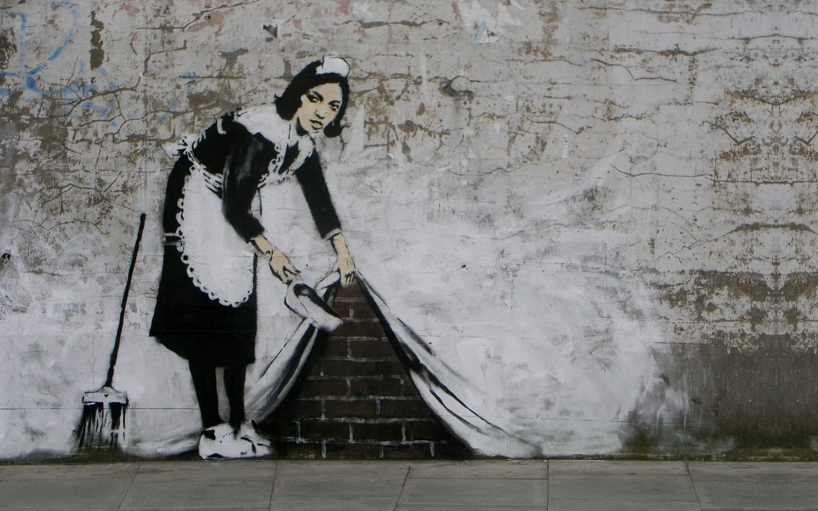 Artistic graffiti on a brick wall depicts a maid sweeping dirt to reveal a clean, white surface beneath, presented as an HD PC desktop wallpaper and background.