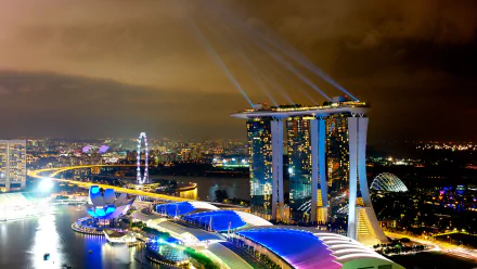 4K Ultra HD night view of Singapore’s Marina Bay Sands and cityscape illuminated with vibrant lights, showcasing the iconic man-made skyline.