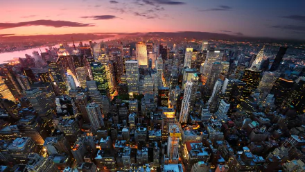 A vibrant HD desktop wallpaper showcasing a breathtaking aerial view of New York City's skyscrapers at sunset, highlighting the iconic cityscape of the USA.