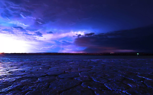 A dramatic seascape featuring a vibrant sky illuminated by lightning, casting a striking glow over textured waters. This HD wallpaper captures the essence of nature's power and beauty.