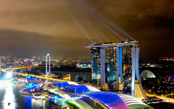 4K Ultra HD night view of Singapore’s Marina Bay Sands and cityscape illuminated with vibrant lights, showcasing the iconic man-made skyline.