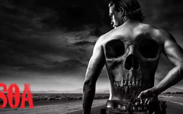 HD desktop wallpaper featuring a Sons of Anarchy theme with a man displaying a large skull tattoo on his back, under a stormy sky, with the SOA logo in red.