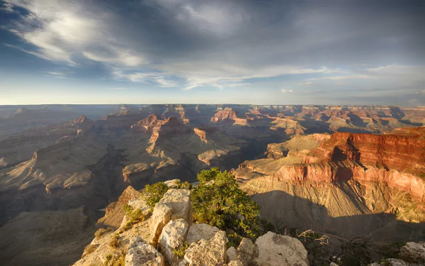 A stunning view of the Grand Canyon, showcasing its dramatic layers and expansive landscape under a vibrant sky. Captured in 4K Ultra HD, this image makes an impressive desktop background.