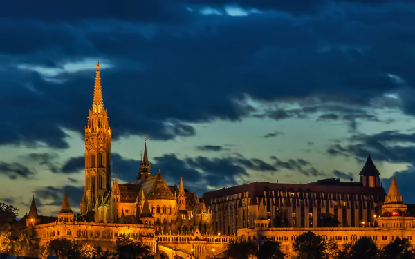 Matthias Church illuminated against a dramatic night sky, captured in stunning 4K Ultra HD as a detailed PC desktop wallpaper.