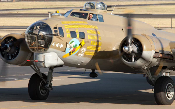 HD PC desktop wallpaper/background: military bomber taxiing on runway, close-up of vivid aircraft nose art, twin radial engines, landing gear and crew visible in the cockpit.