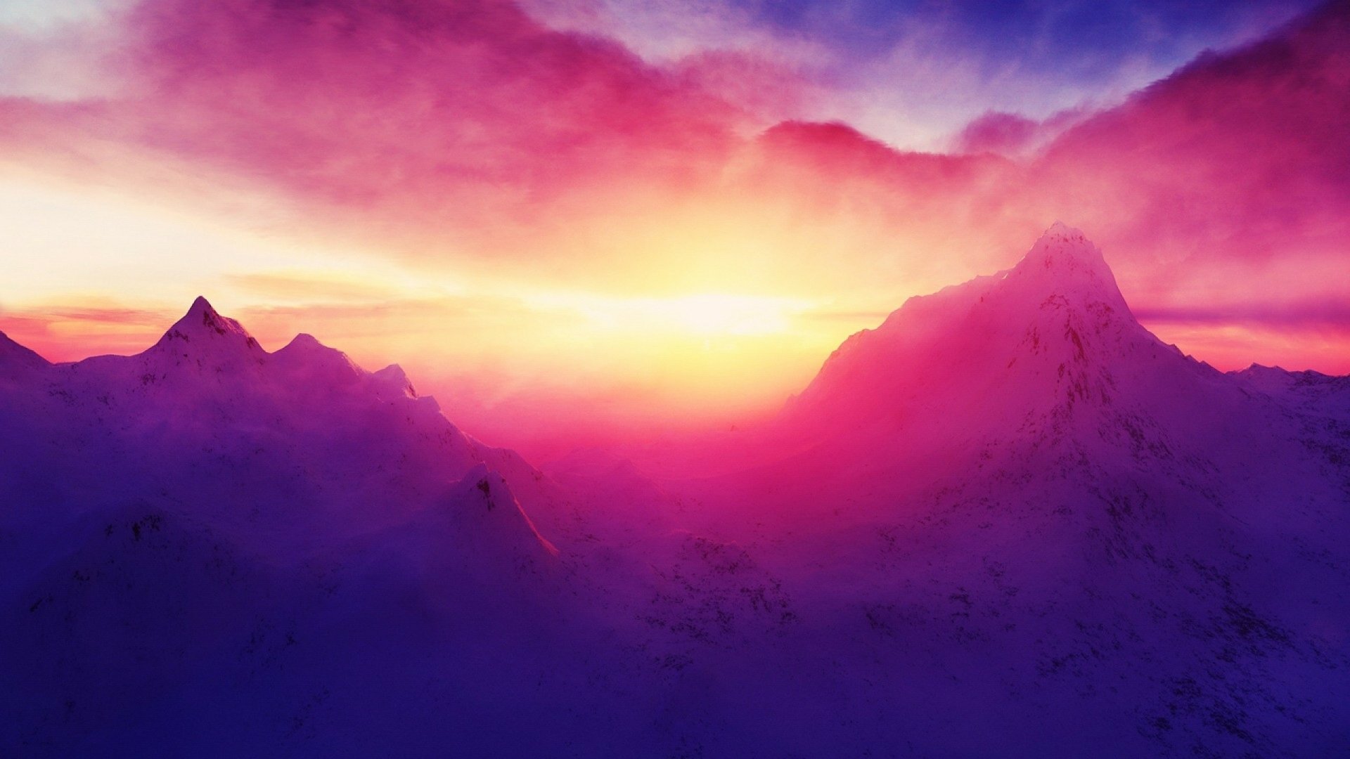 A stunning HD desktop wallpaper featuring colorful clouds illuminating the sky above majestic mountains at sunset, creating a serene and captivating natural scene.