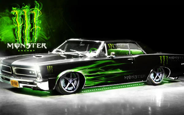 A sleek black car with green Monster Energy logos and flames stands out against a dark background, designed as an HD desktop wallpaper showcasing man-made automotive creativity.