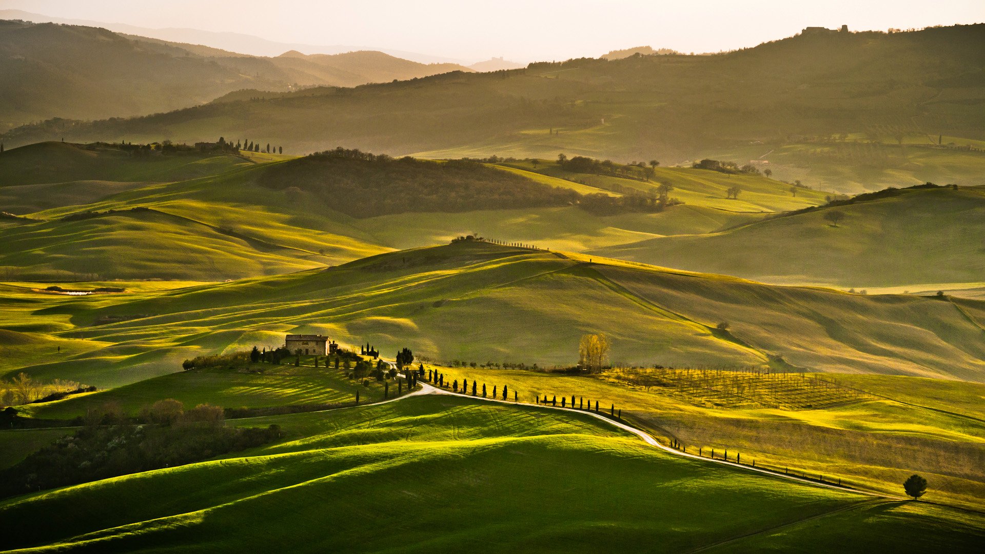HD landscape photography featuring rolling green hills and softly lit valleys, captured as a serene desktop wallpaper and background.
