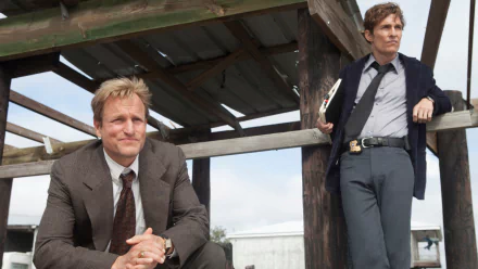 HD PC desktop wallpaper featuring Woody Harrelson and Matthew McConaughey from the TV show True Detective in a rustic outdoor setting.