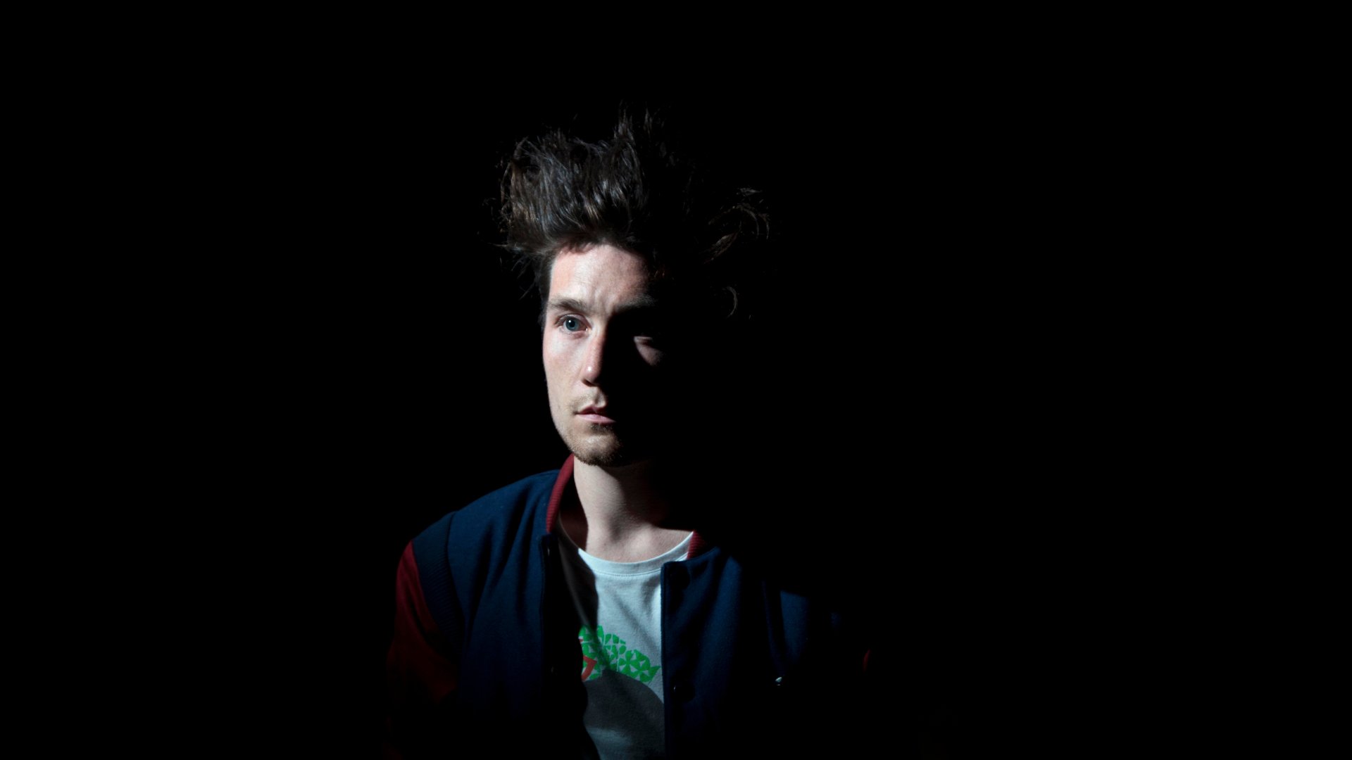 Portrait of a Bastille band member against a dark background, featured in a 4K Ultra HD English rock band desktop wallpaper.