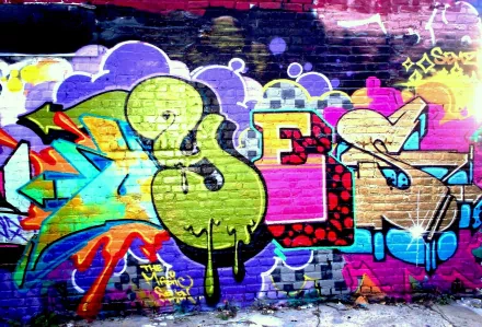 HD desktop wallpaper featuring vibrant, colorful graffiti with artistic patterns on a brick wall as background.
