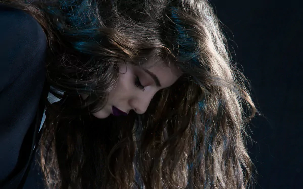 HD PC desktop wallpaper featuring a close-up profile of Lorde with flowing hair against a dark background, capturing a moody and artistic music-themed vibe.