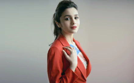 HD desktop wallpaper featuring Bollywood actress Alia Bhatt, an Indian celebrity with brunette hair, wearing a red blazer against a neutral background.