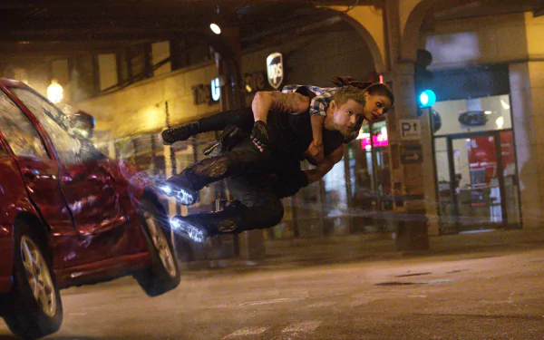 HD desktop wallpaper from Jupiter Ascending featuring a character in dynamic mid-air action above a city street at night.