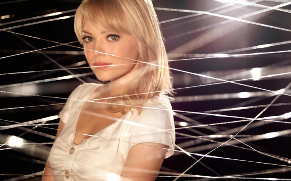 A woman with blonde hair poses amidst intricate strands of webbing, capturing the essence of The Amazing Spider-Man in this high-definition desktop wallpaper.