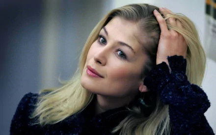 HD desktop wallpaper featuring a posed portrait of Rosamund Pike with a contemplative expression.