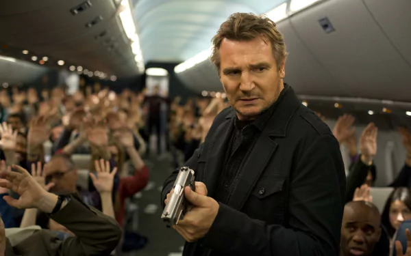 HD desktop wallpaper featuring actor in a tense airplane scene, holding a gun with passengers in the background.