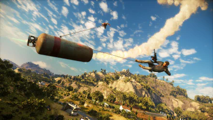 HD PC desktop wallpaper featuring Rico Rodriguez from Just Cause 3 mid-action, gliding through the sky with a massive bomb in a vibrant video game landscape.