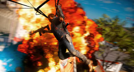 Rico Rodriguez from Just Cause 3 glides through the air on a grappling hook against a fiery explosion backdrop in this HD PC desktop wallpaper.