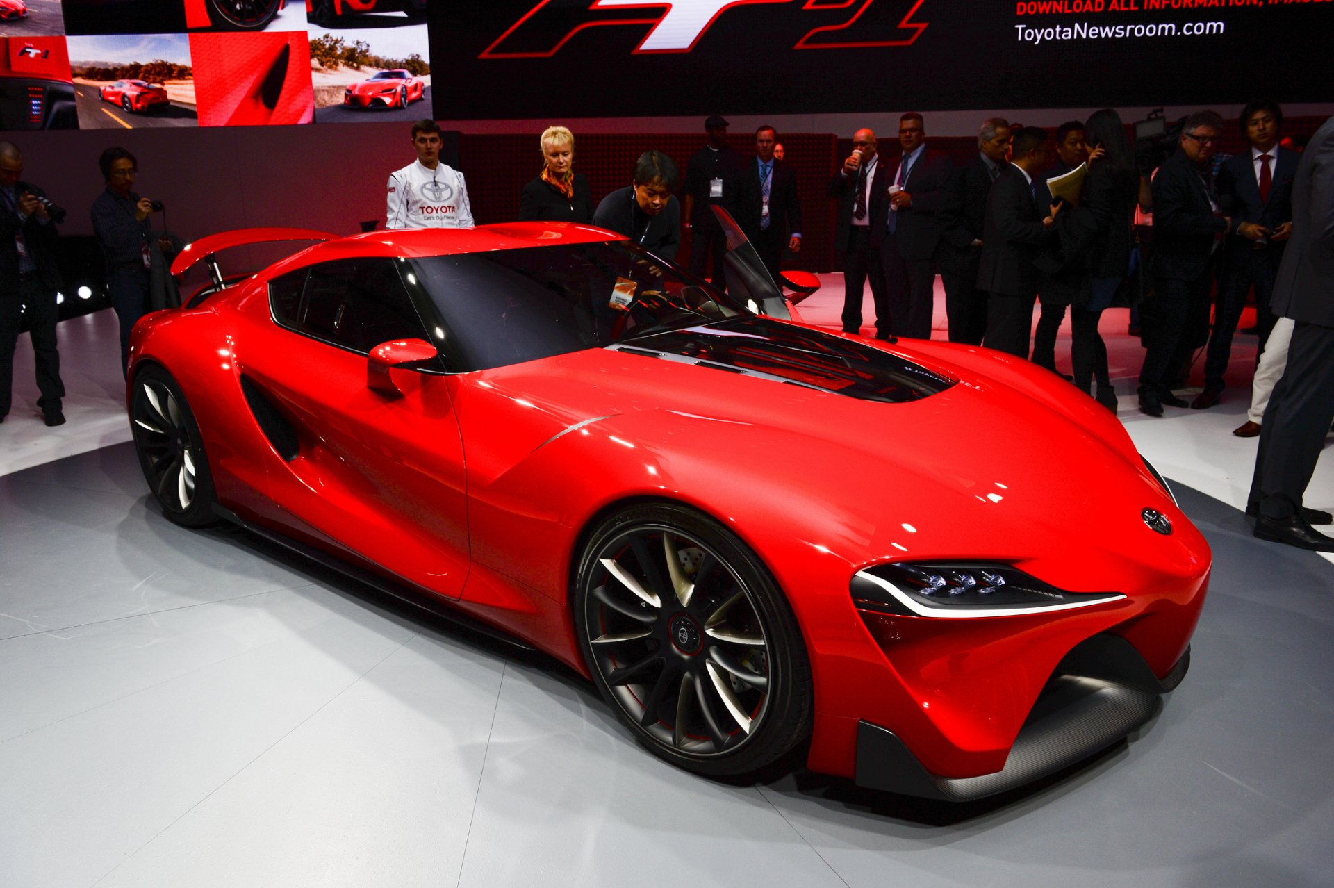 Red Toyota FT-1 supercar concept displayed at an auto show, featured as an HD PC desktop wallpaper and background.