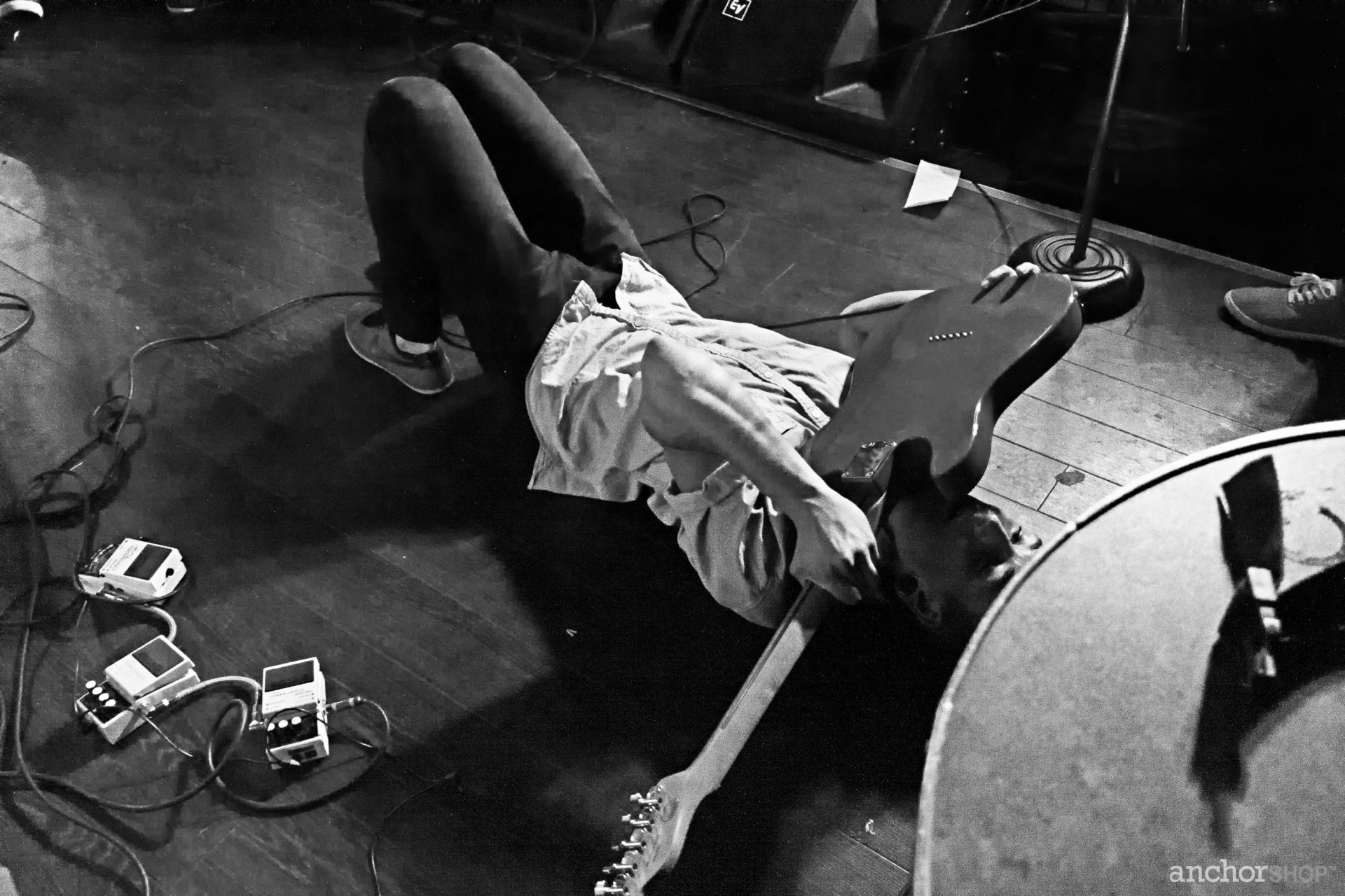 HD desktop wallpaper of a Being As An Ocean concert, featuring a dynamic black and white shot of a guitarist lying on stage.