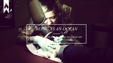 HD desktop wallpaper featuring the title Being As An Ocean with a tattooed individual working diligently.