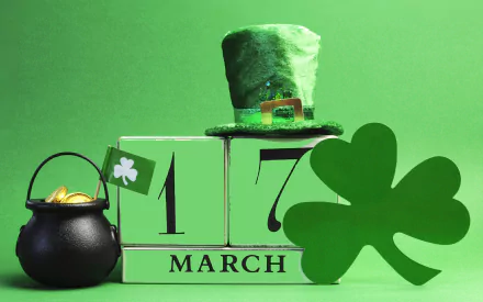 A vibrant St. Patrick's Day desktop wallpaper featuring a green top hat, a pot of gold, and festive decorations, celebrating March 17 with a lively, cheerful vibe.